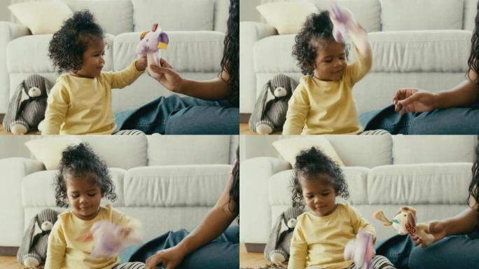 Cute baby girl playing with toys bonding with her 