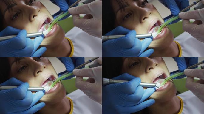 在现代牙科诊所检查女性患者牙齿的男性牙医和牙科护士的手