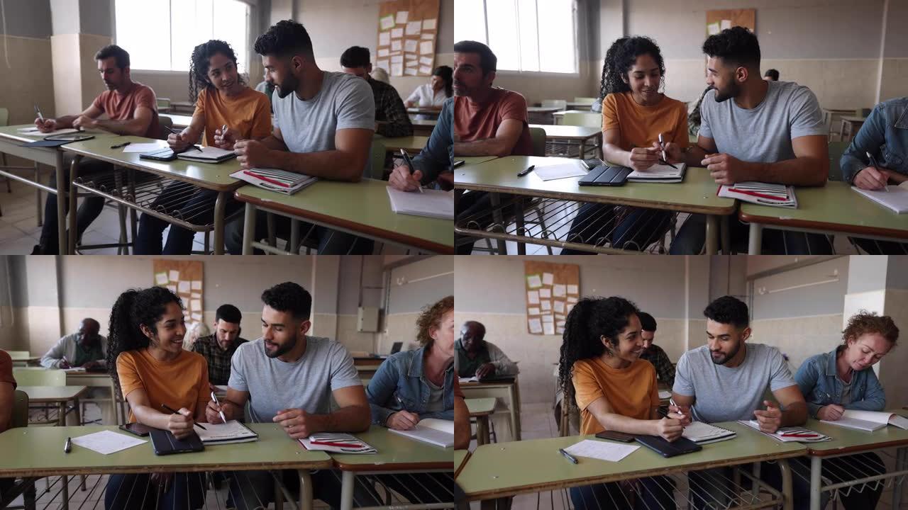 学生夫妇在课堂上一起做作业，其余的则在自己的笔记本上工作