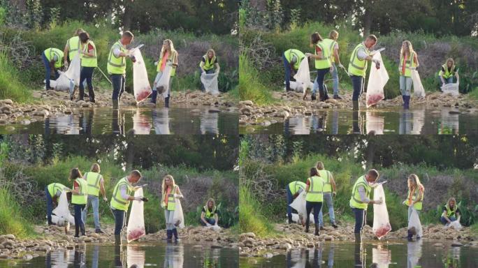 在河清理日期间，身穿黄色背心的成年成年人志愿服务