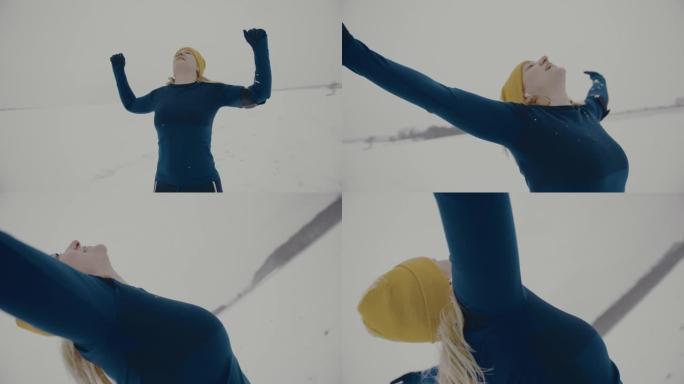 SLO MO欣喜若狂的女人在雪地里慢跑时举起手臂到滑雪板上