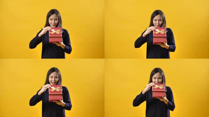黄色工作室拍摄: 女人打开情人节礼盒