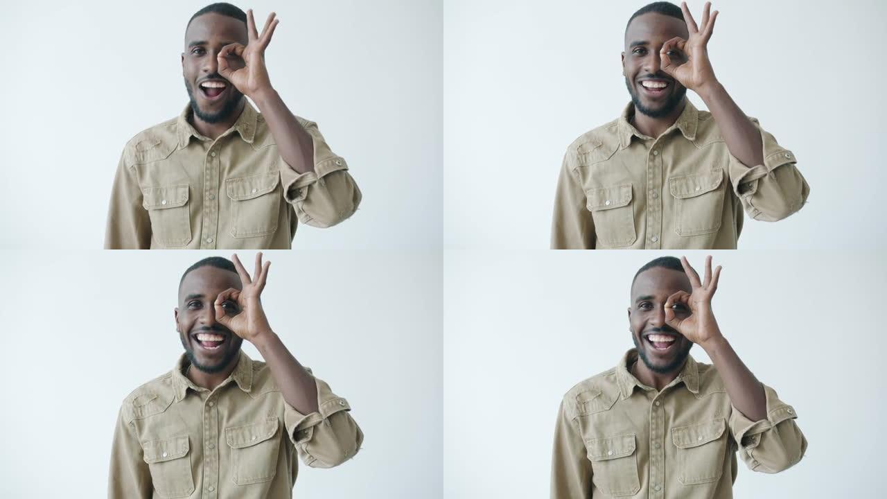 快乐的非洲裔美国人通过OK手势微笑着看着相机的慢动作