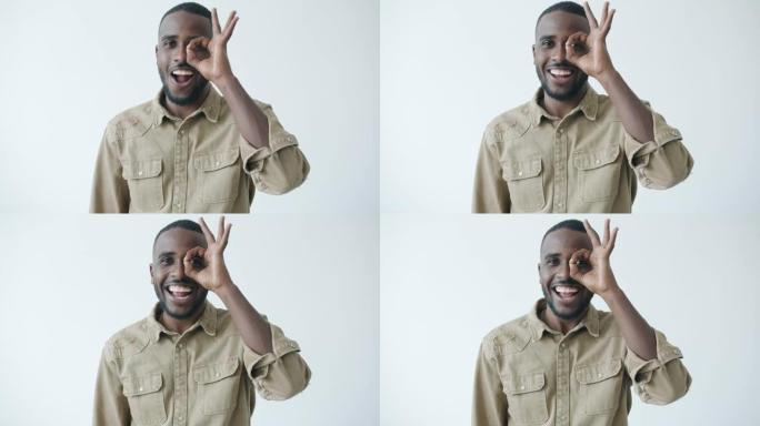 快乐的非洲裔美国人通过OK手势微笑着看着相机的慢动作
