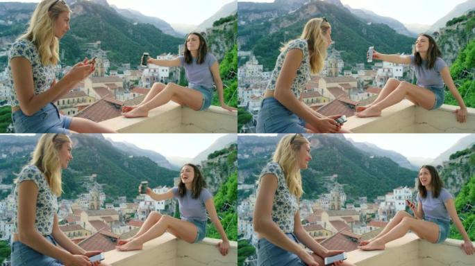 两名年轻女性在意大利度假时在公寓阳台上使用智能手机的4k视频片段