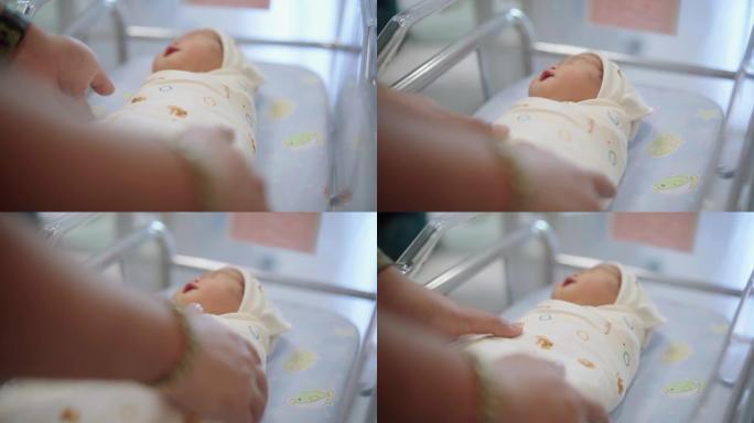 父亲和母亲牵着新生儿在医院的手