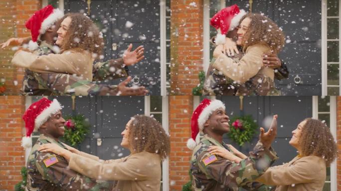 在雪景拍摄的慢镜头中，一对夫妇和戴着圣诞帽的美国军人丈夫在度假时在屋外拥抱