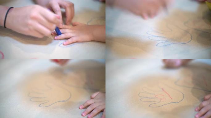 手绘儿童手的轮廓。孩子在白纸上画画。