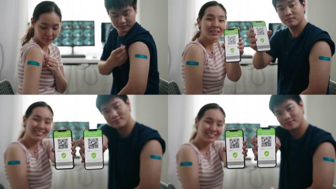 亚洲夫妇在接种疫苗后从智能手机屏幕上展示针对新型冠状病毒肺炎的疫苗品牌和数字疫苗护照预防健康