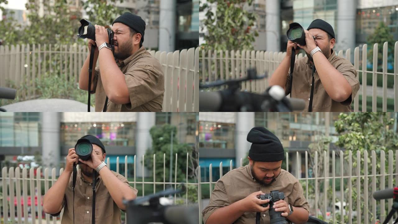 亚洲男摄影师在城市拍照