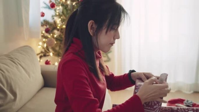 新型冠状病毒肺炎期间坐在家里准备圣诞节的亚洲妇女