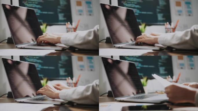 年轻的亚洲开发者在现代办公室的电脑桌面上编码移动应用程序