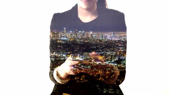 女士使用智能手机叠加在夜间拍摄的城市景观上
