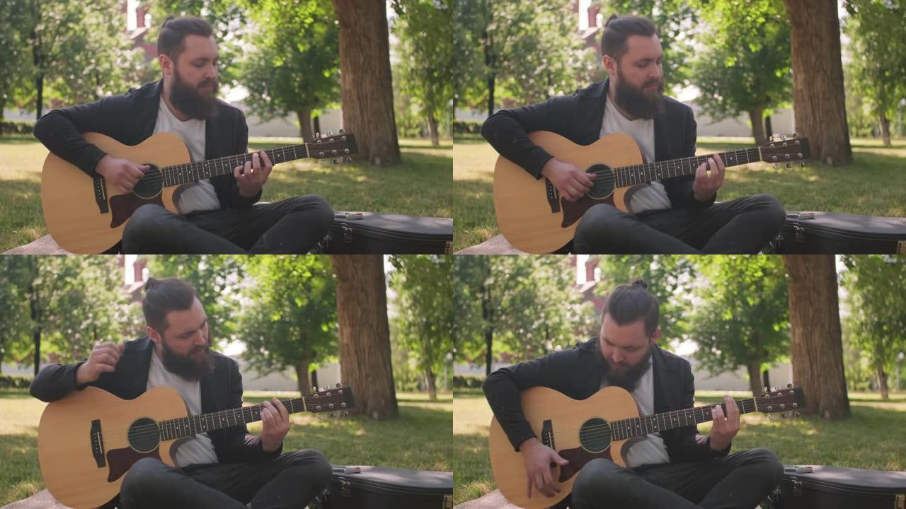 留着胡子的男人在公园弹吉他