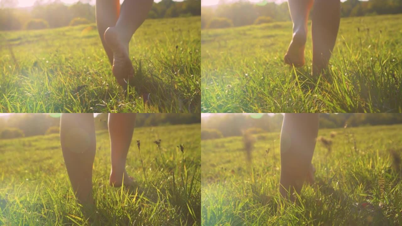 特写，低角度: 金色灯光下赤脚踱步草的女士后视