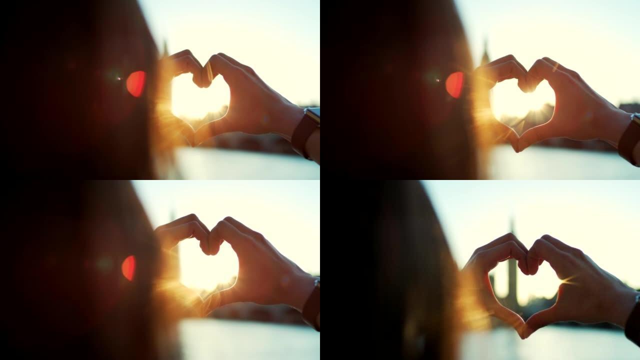 4k视频片段，一名年轻女子在探索城市时表现出心脏手势