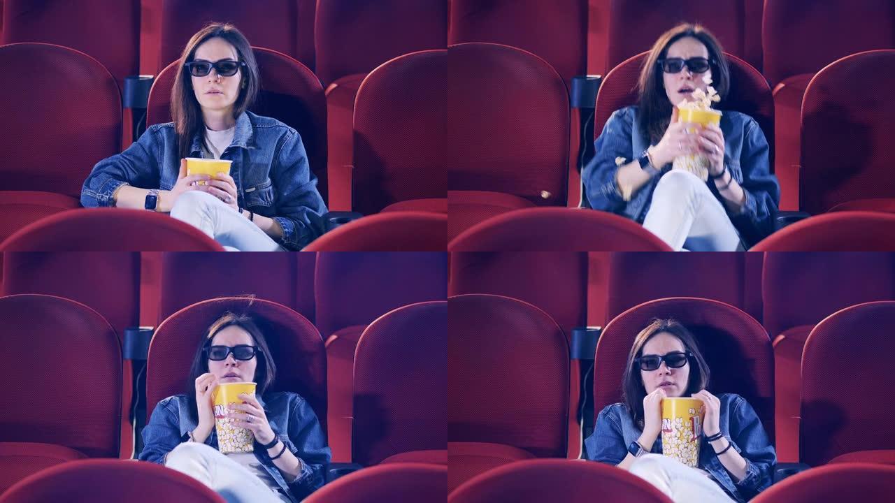 戴3D眼镜的女人在看恐怖电影时感到害怕