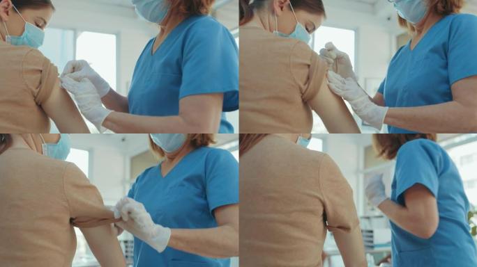 4k视频片段，一名无法辨认的护士在给她的病人注射了Covid疫苗后给她贴了创可贴