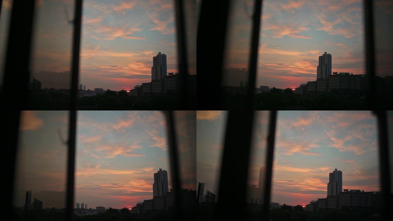 日落透过窗户看城市，日落在窗户上反射
