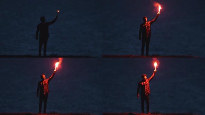 那个英俊的男人站在海边，拿着一根火棍。慢动作