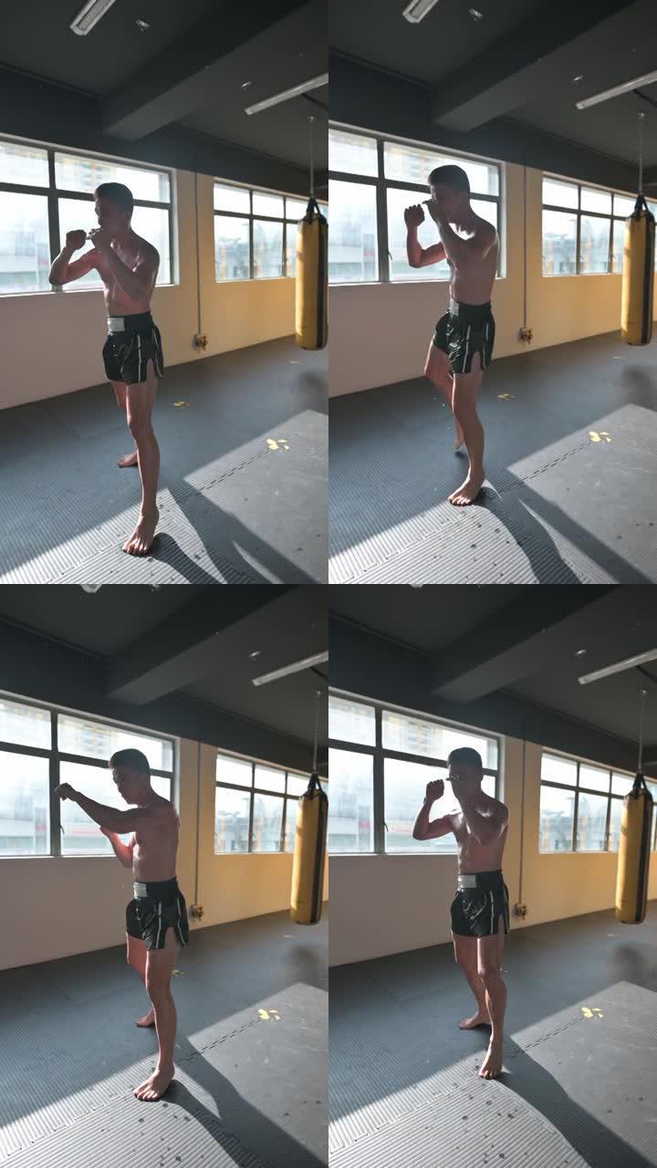 影子拳击亚洲中国泰拳拳击手在健身房练习拳击空气