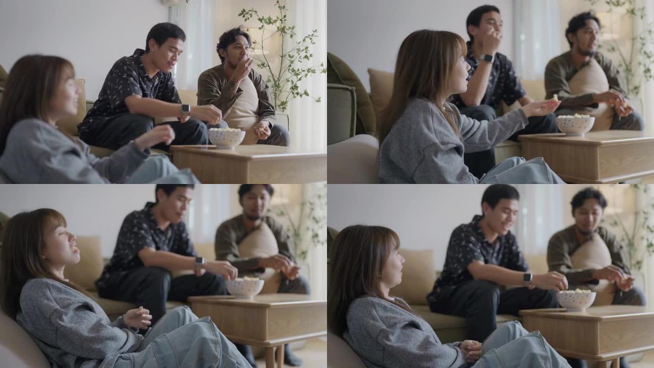 亚洲男子手臂残疾和他的朋友在家里看电视。