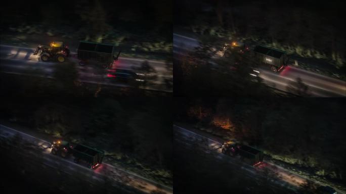 空中拍摄夜间在乡村道路上行驶的拖拉机
