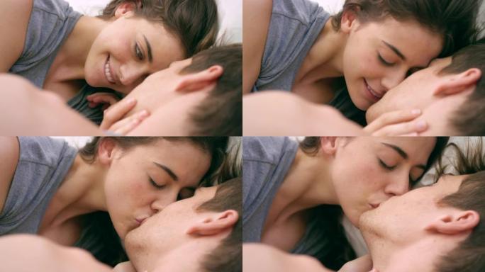 一对年轻夫妇在家里的床上接吻的4k视频片段