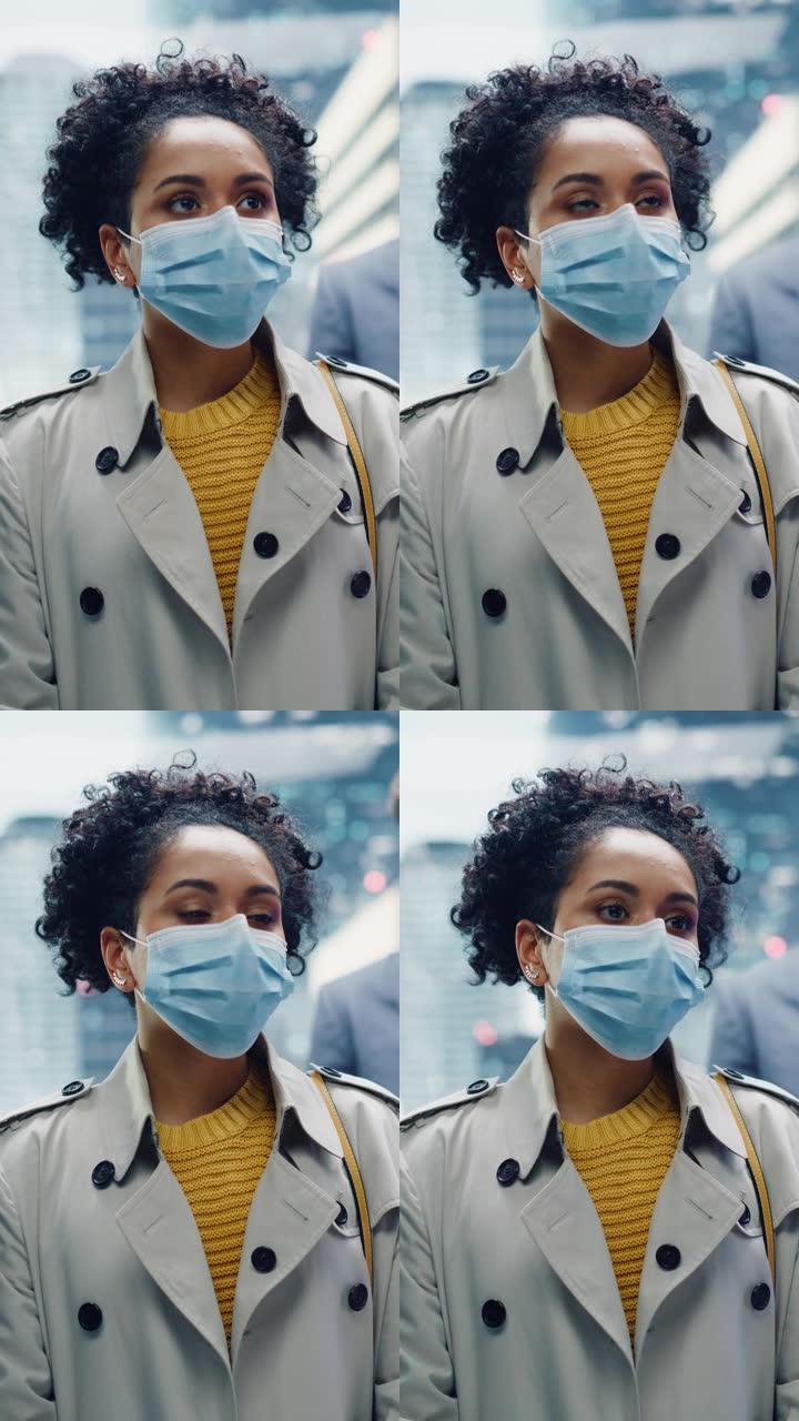 垂直屏幕: 多民族黑人拉丁女性戴着防护口罩，乘坐玻璃电梯到商务中心的办公室。医疗保健、新型冠状病毒肺