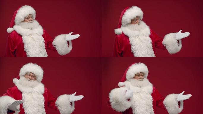 圣诞老人用手展示复制空间，站在红色背景上