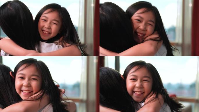 女儿抱着母亲，看着镜头。然后带着欢快的心情对着镜头微笑，它代表着母子的爱和温暖。