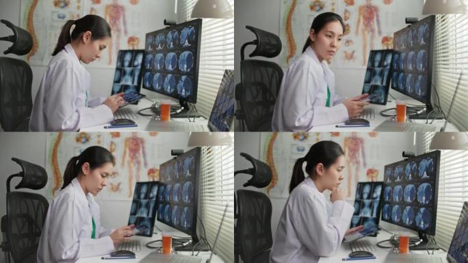 多莉拍摄的女医生在办公桌上处理x射线图像
