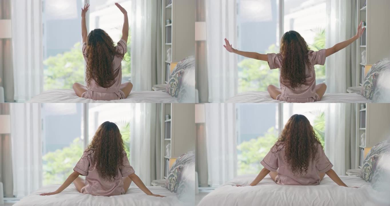 一名年轻女子在床上醒来的4k视频片段感到精神焕发