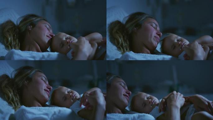年轻的和平的neo母亲的真实电影拍摄是在晚上在托儿所的床上睡觉时爱抚她的新生婴儿。