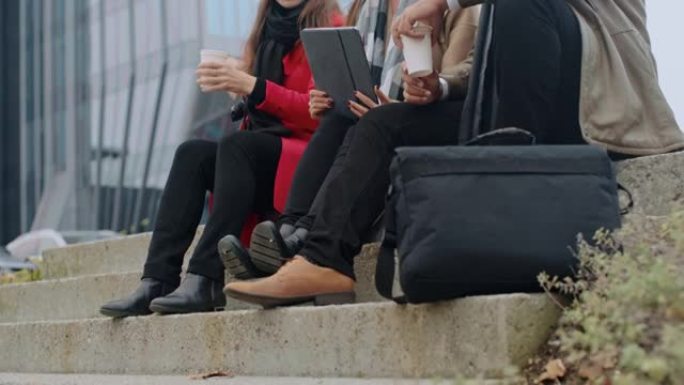 DS三位同事在外面喝咖啡休息时使用数字平板电脑