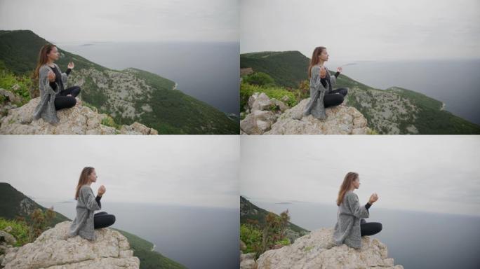 坐在悬崖上沉思的年轻女子