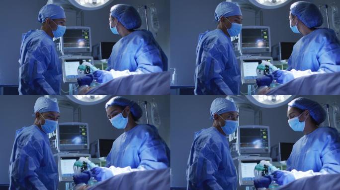 混血外科医生穿着防护服在手术室看心脏监护仪
