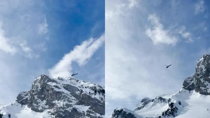 低角度视图: 直升机飞越白雪皑皑的山峰，滑雪者开始骑行