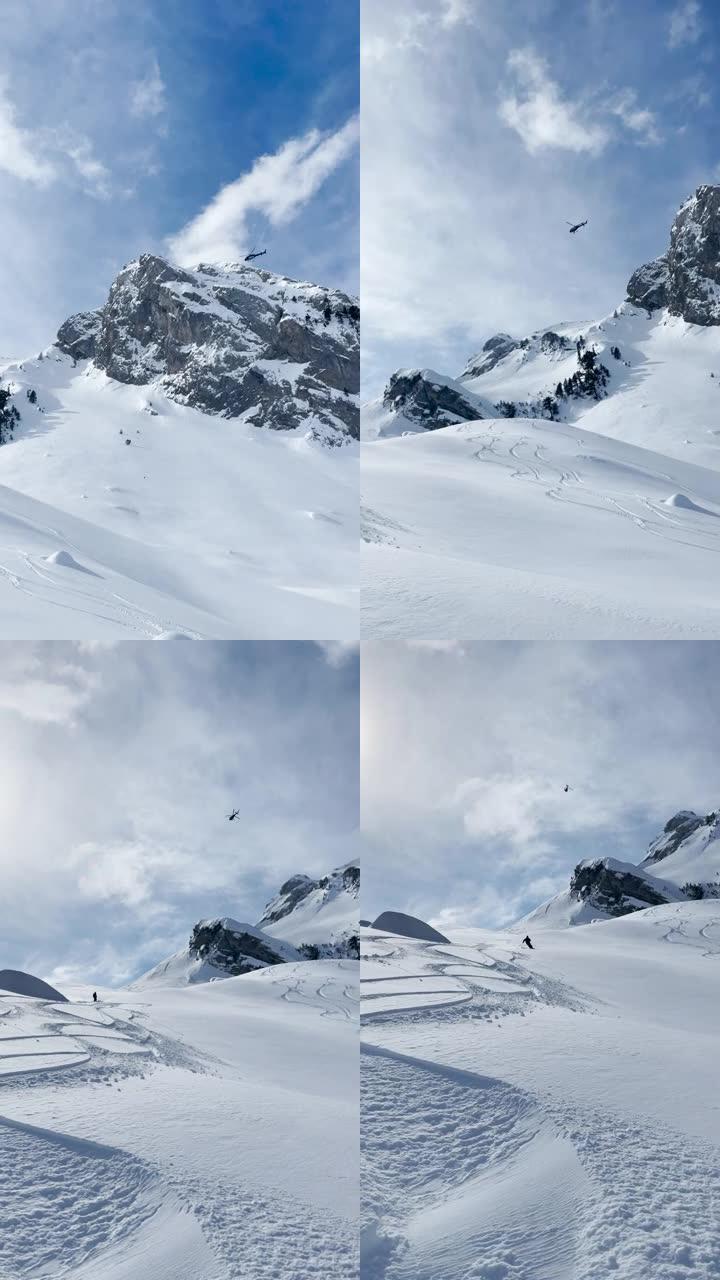 低角度视图: 直升机飞越白雪皑皑的山峰，滑雪者开始骑行