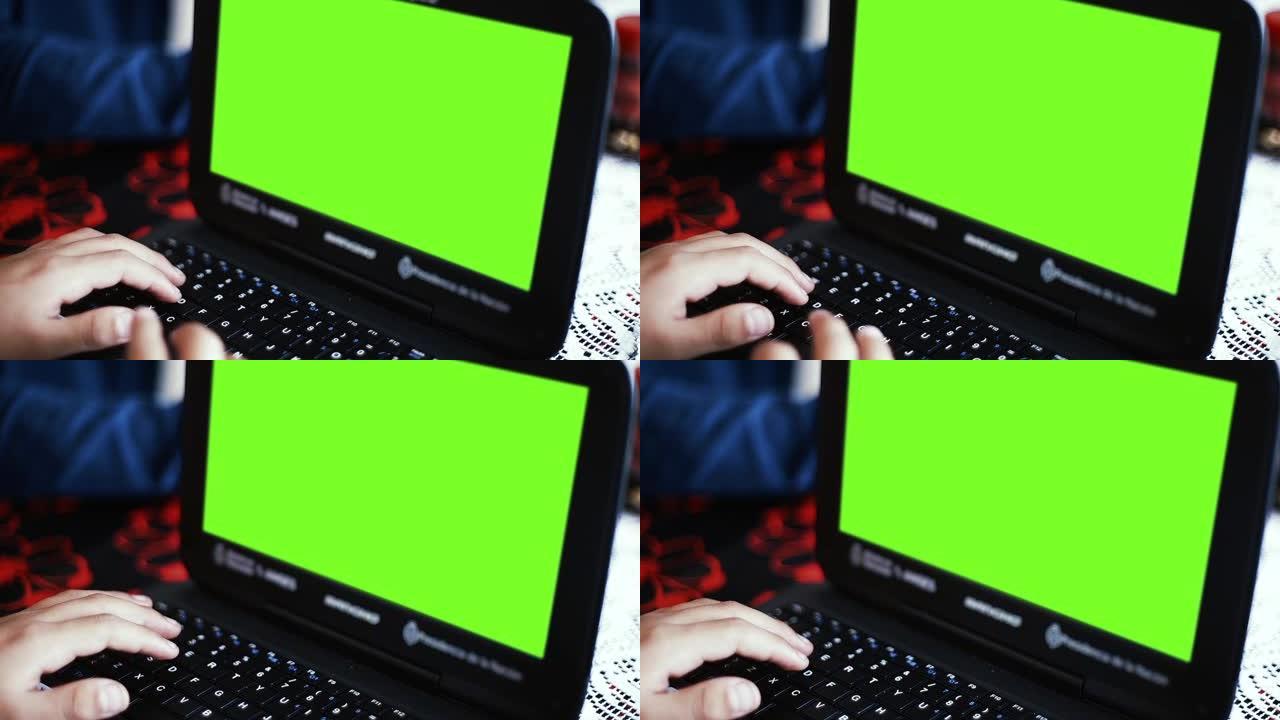 黑色笔记本电脑，带绿色色度键屏幕。放大。