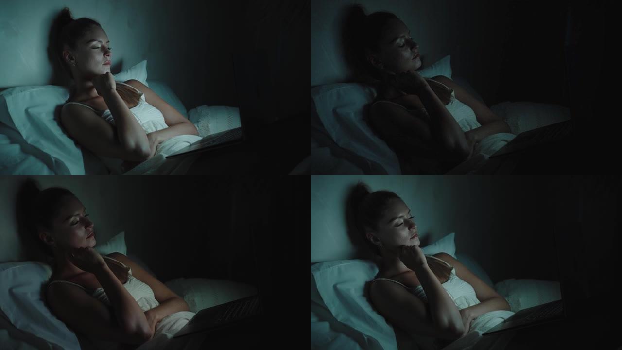 女人在床上看电影躺在床上看电视的女人失眠