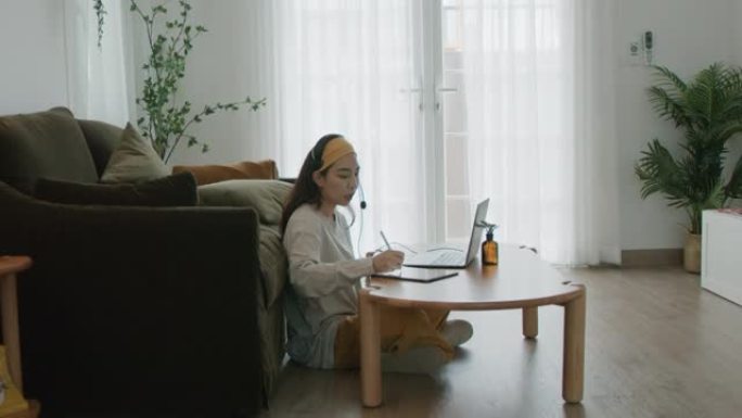 年轻女性与同事在家视频会议。