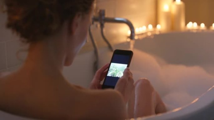 4k视频片段，一名妇女在智能手机上滚动浏览照片