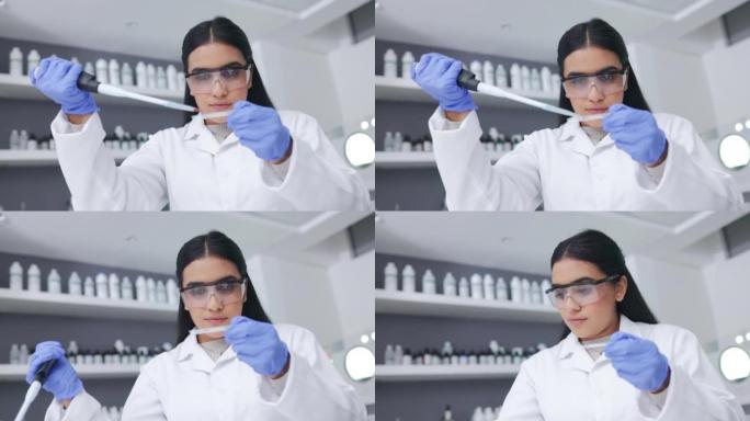 年轻的女科学家在独自在实验室工作时进行研究以找到治愈疾病的方法。认真而专业的医学生物学家正在进行一项