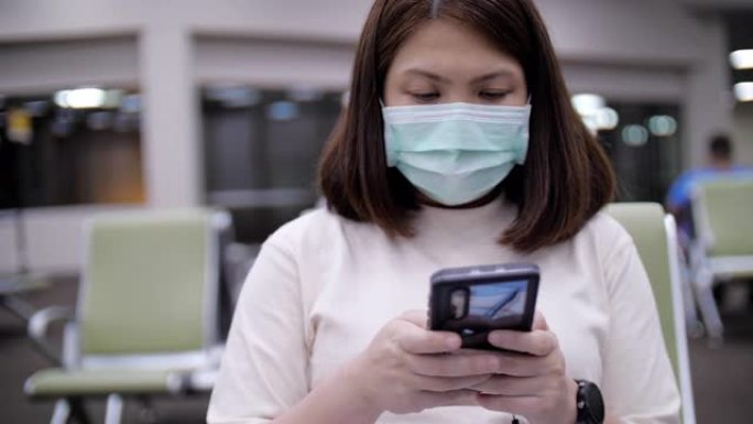 亚洲妇女戴着口罩在机场远离新型冠状病毒肺炎病毒