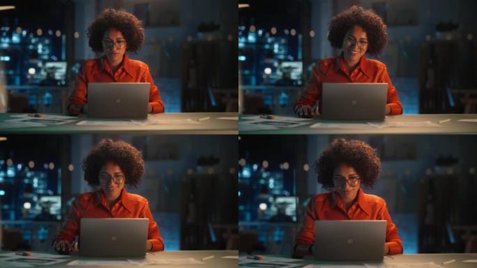 晚上在创意办公室工作的年轻黑人女性在笔记本电脑上工作。快乐的多民族项目经理写电子邮件，在线研究项目计