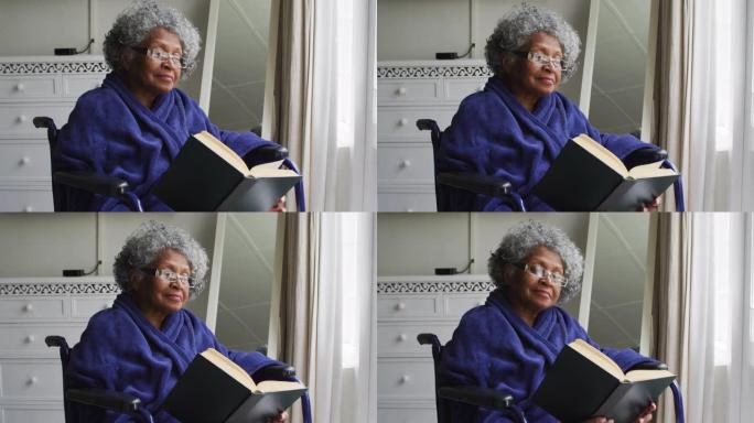 资深非裔妇女坐在轮椅上在家看书