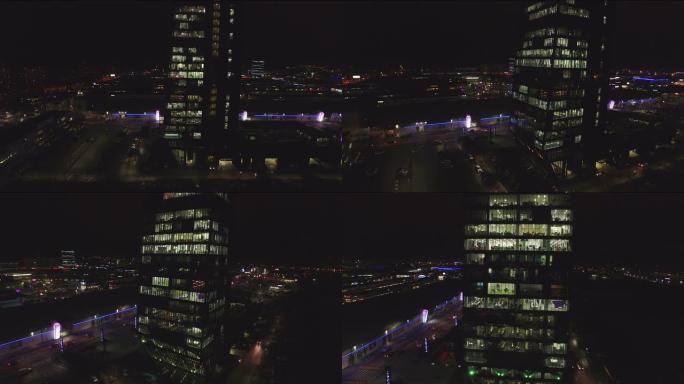 天线: 夜间在大型办公室摩天大楼工作的商人