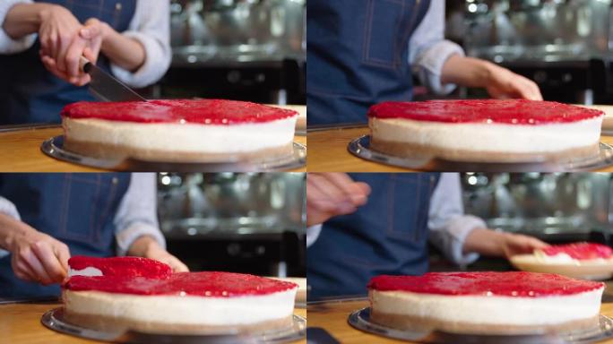 提供一部分rasberry芝士蛋糕的咖啡馆女服务员的特写镜头