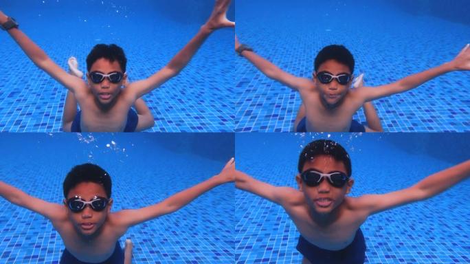 暑假在游泳池里快乐的亚洲男孩